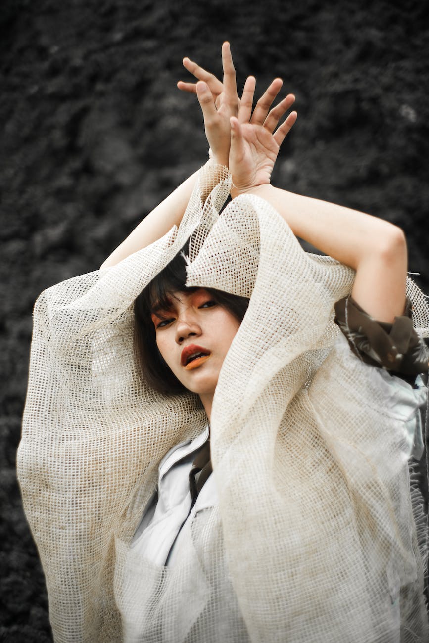 photo of woman putting her hands up
