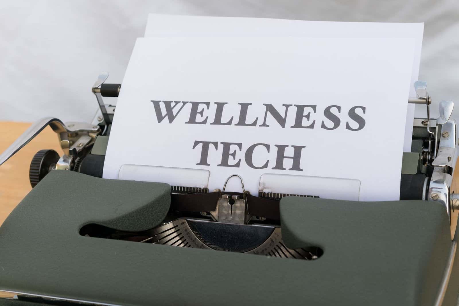 a typewriter with the word wellness tech on it