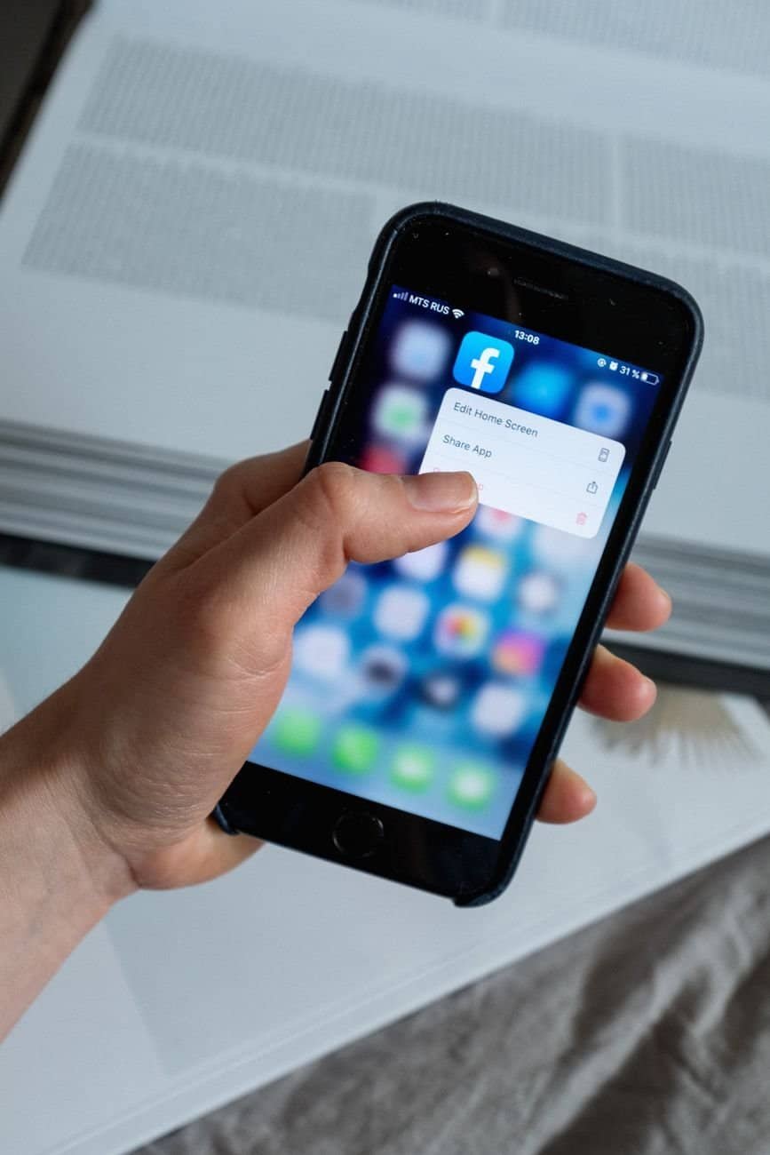 crop faceless person touching smartphone screen with pop up window