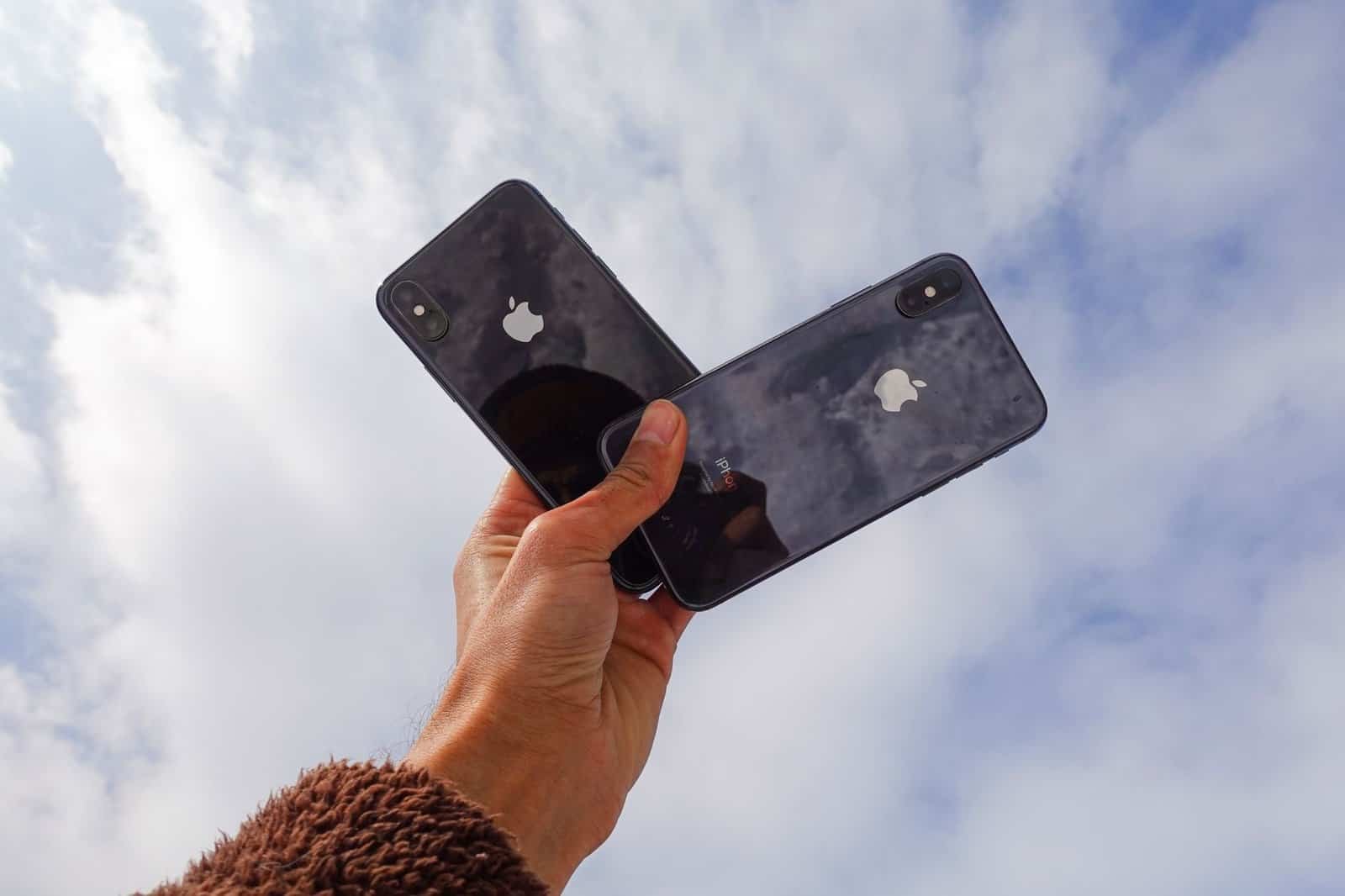 close up photo of a person holding cellphones