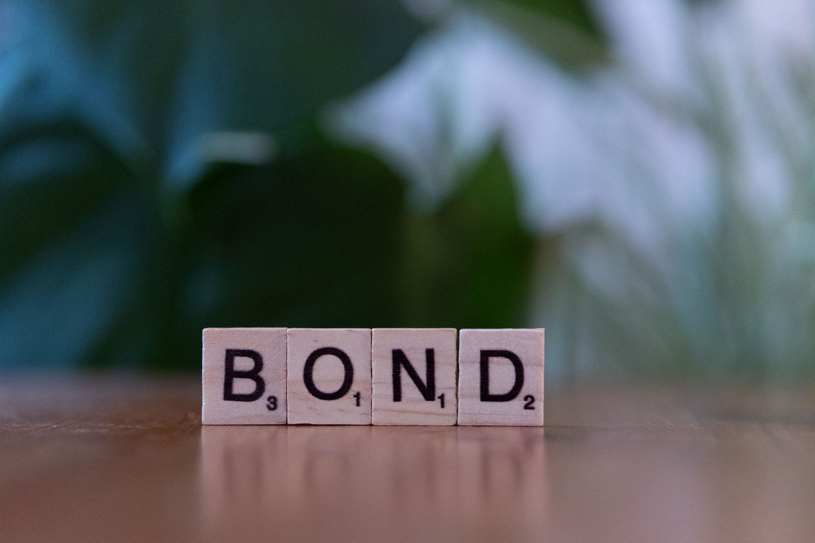 bond scrabble tiles on wooden table