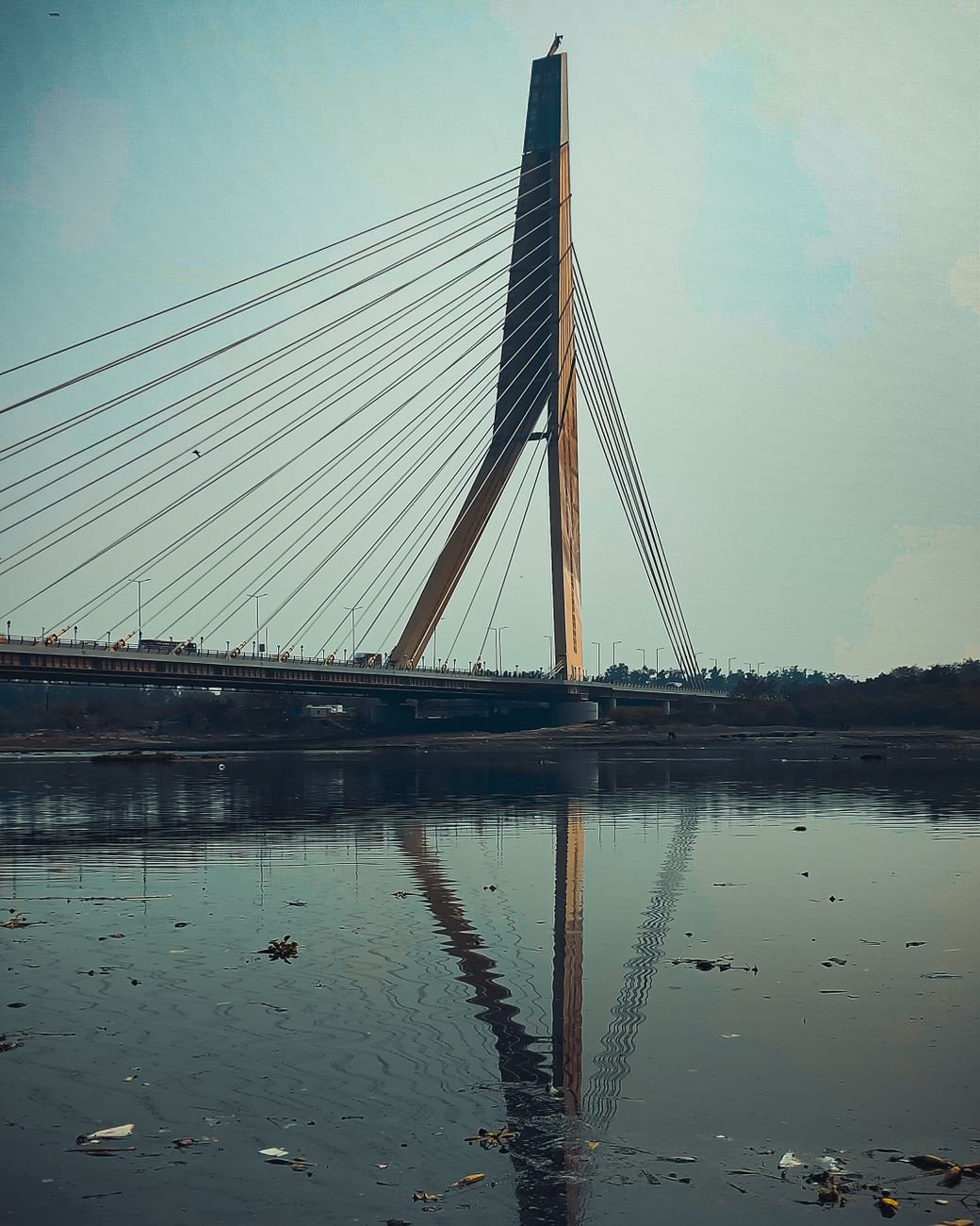 suspension bridge over polluted river