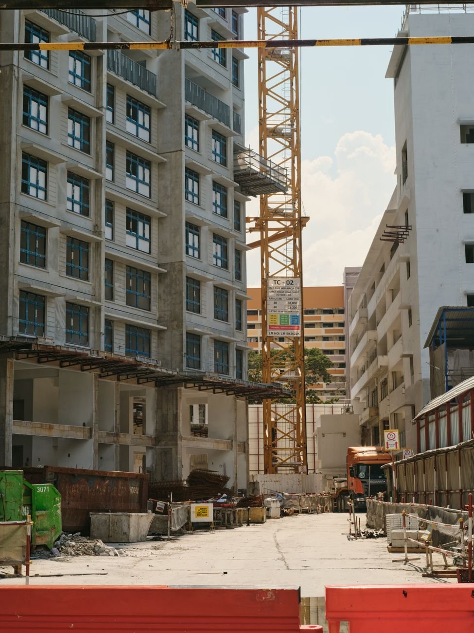 urban construction site with tower crane and buildings
