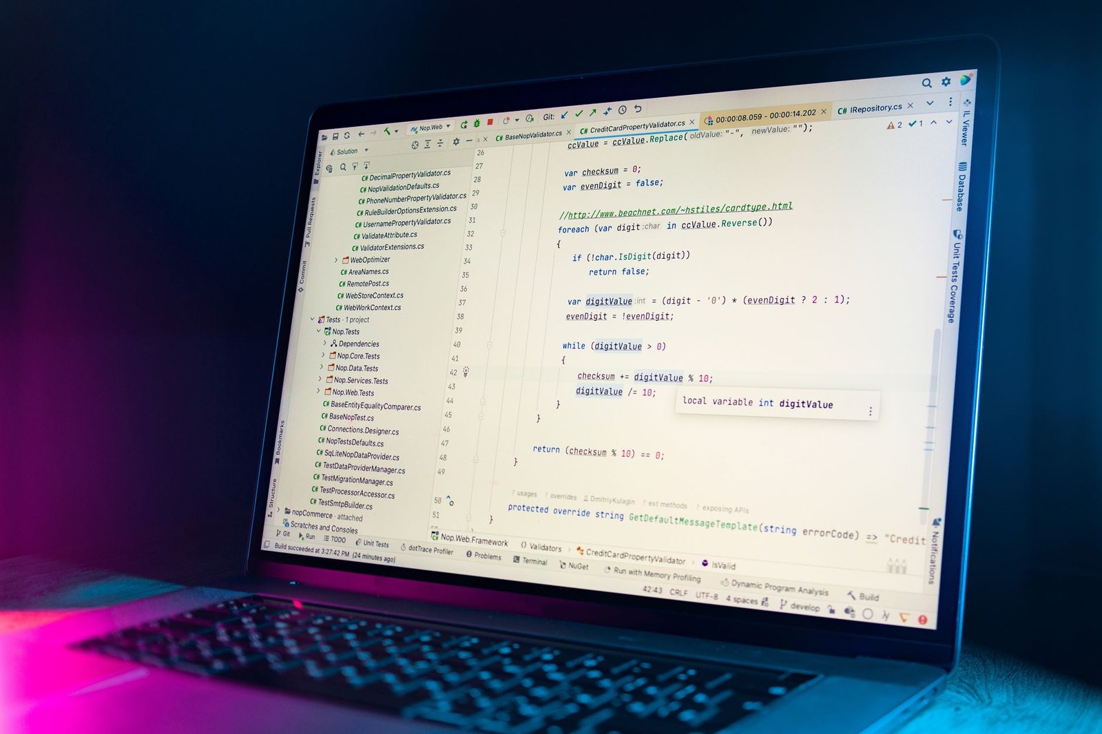 laptop with code editor displaying programming code