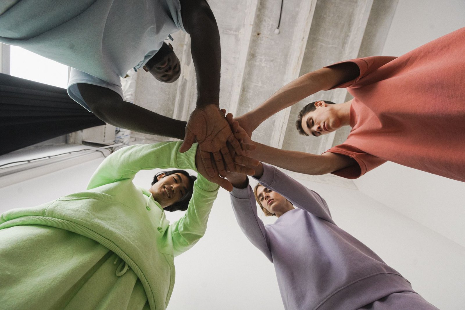 group of men with their hands together